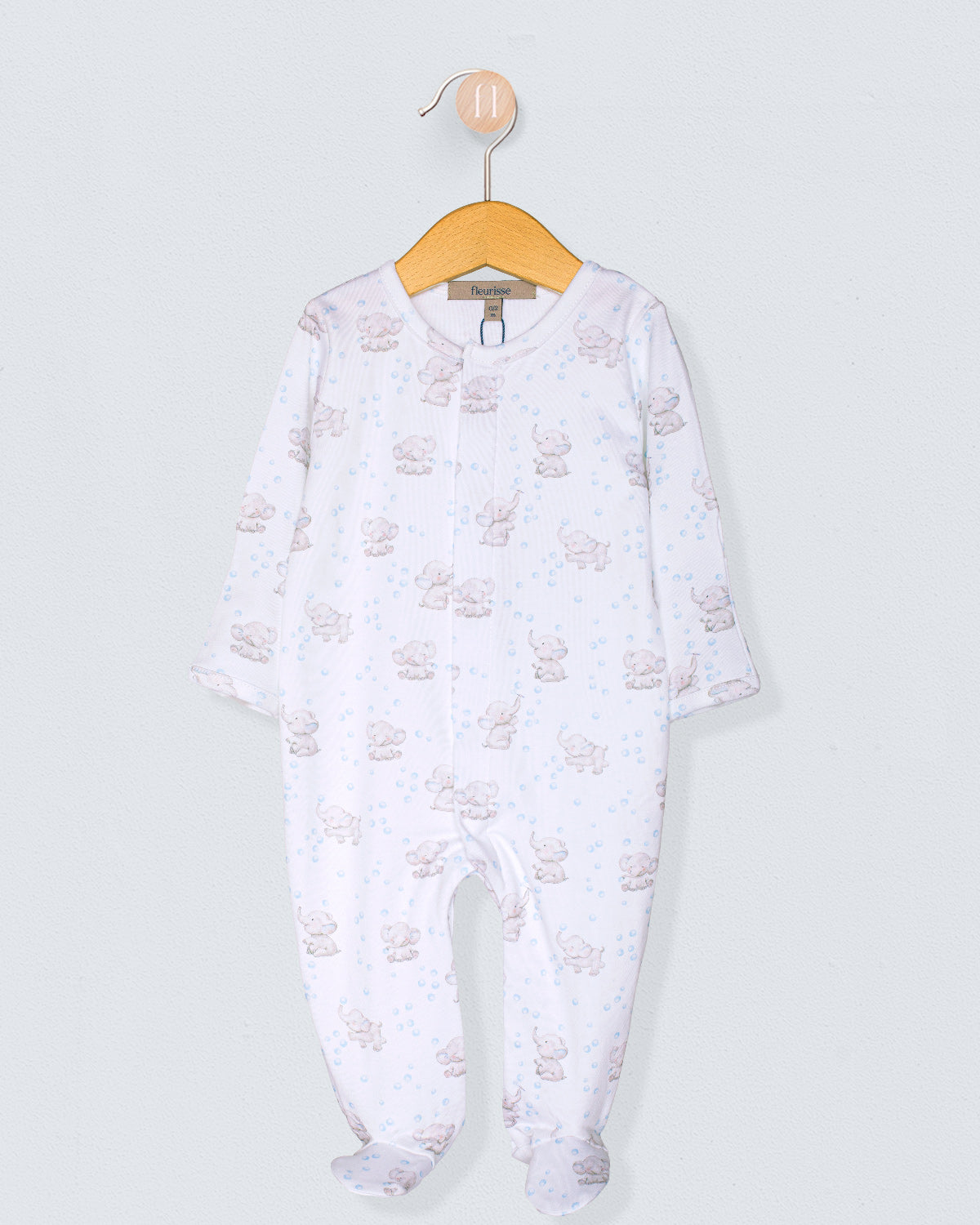 Baby onesie with a pattern on a hanger against a light gray background