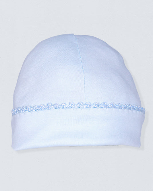 Light blue beanie with lace detail on a light gray background