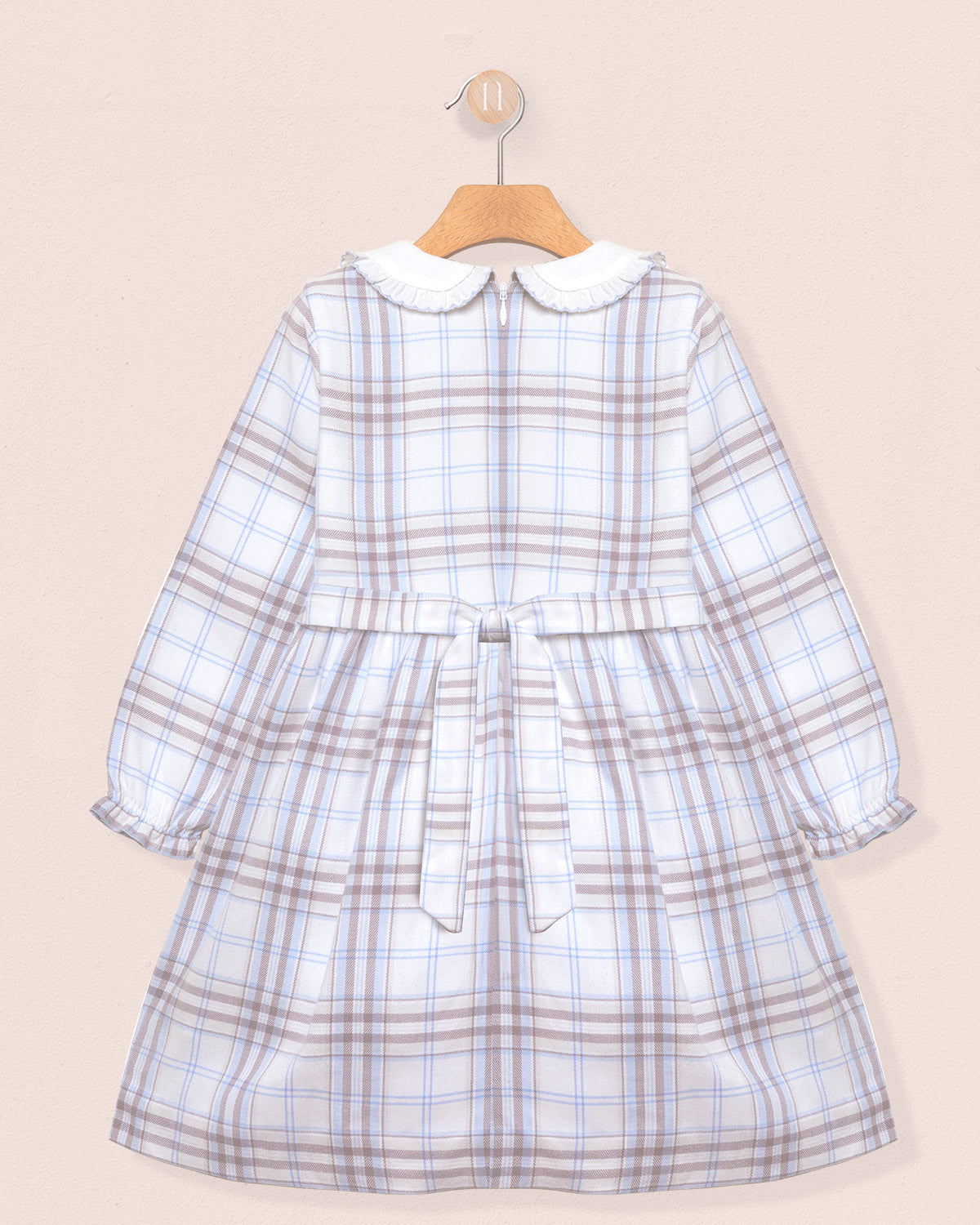 Plaid dress with a collar on a beige background