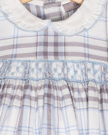 Close-up of a plaid dress with a visible brand label on a white background