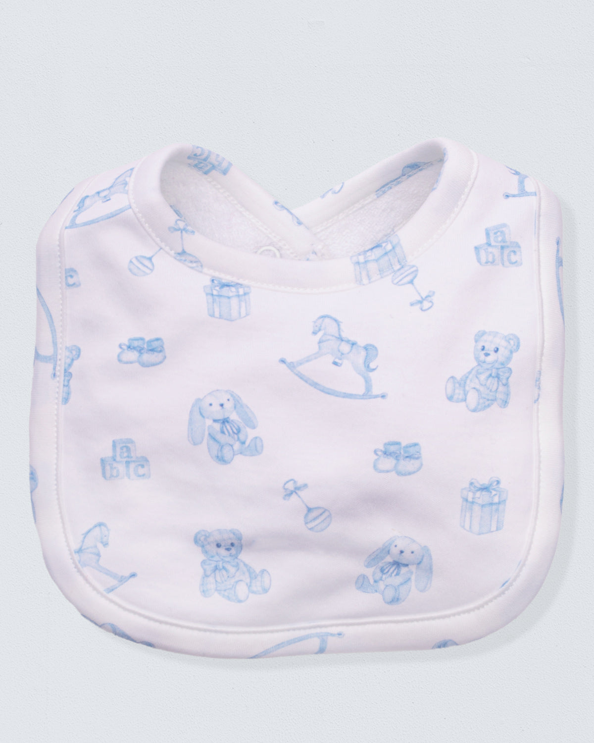 White bib with blue teddy bear pattern on a light gray background