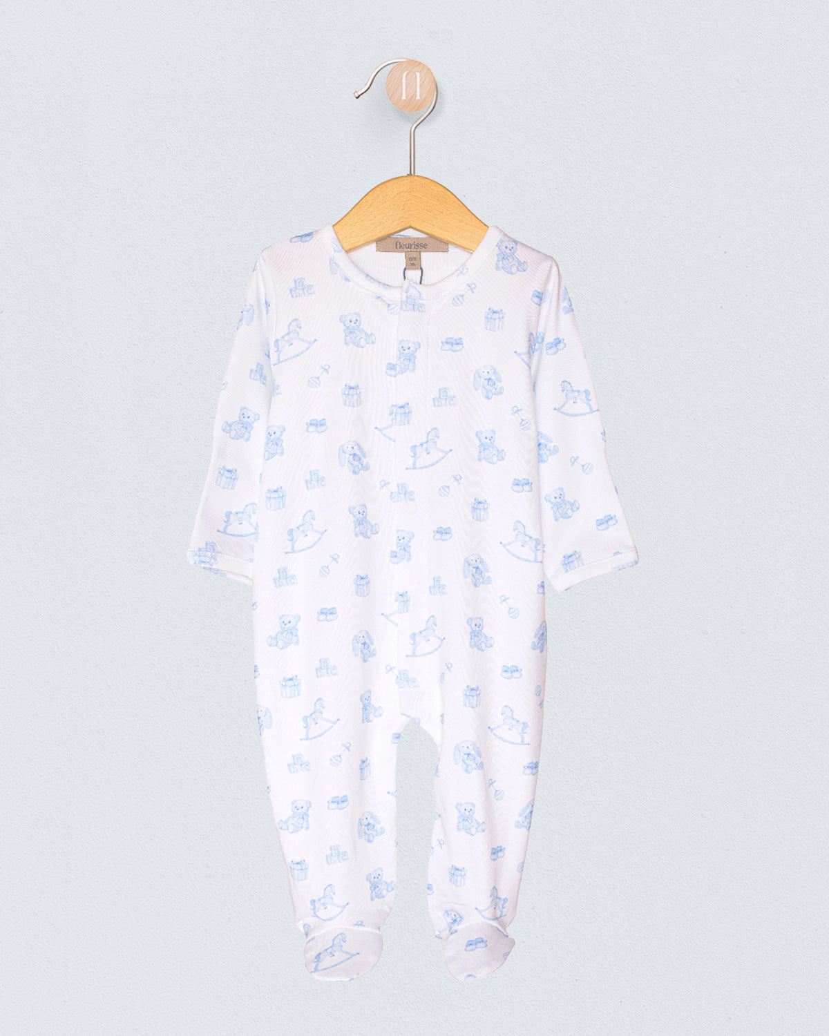 Baby onesie with blue floral pattern on a hanger against a light gray background