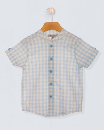 light blue and white checkered shirt with blue buttons on a wooden hanger against a light blueish grey backdrop