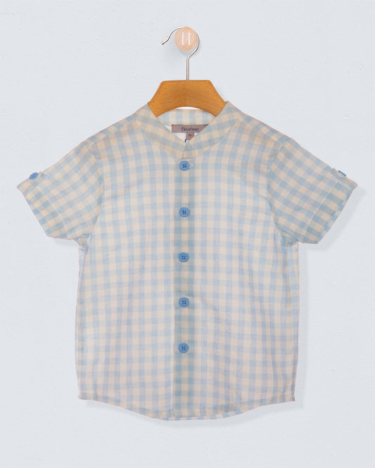 light blue and white checkered shirt with blue buttons on a wooden hanger against a light blueish grey backdrop