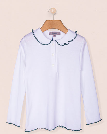 Long sleeve white cotton blouse for girls with pine green scalloped trim on the collar and cuffs, displayed on a wooden hanger against a light pink background.