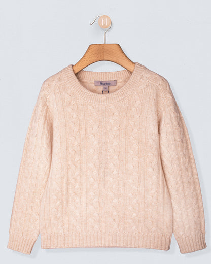 Beige cashmere sweater on a wooden hanger against a light gray background