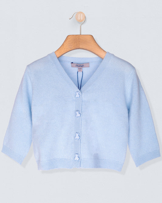 Light blue cardigan on a wooden hanger against a light gray background