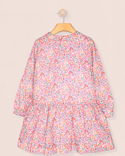 Floral dress on a hanger against a beige background back view