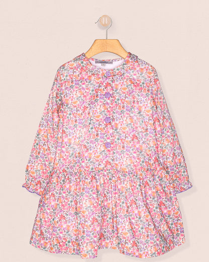 Floral dress on a hanger against a beige background