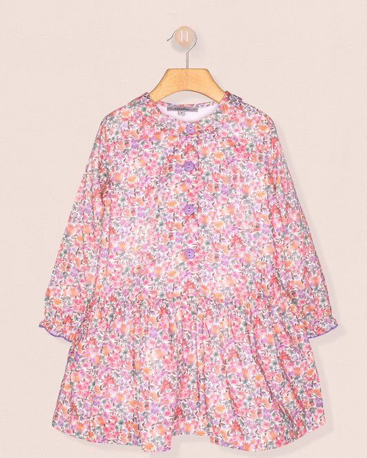 Floral dress on a hanger against a beige background