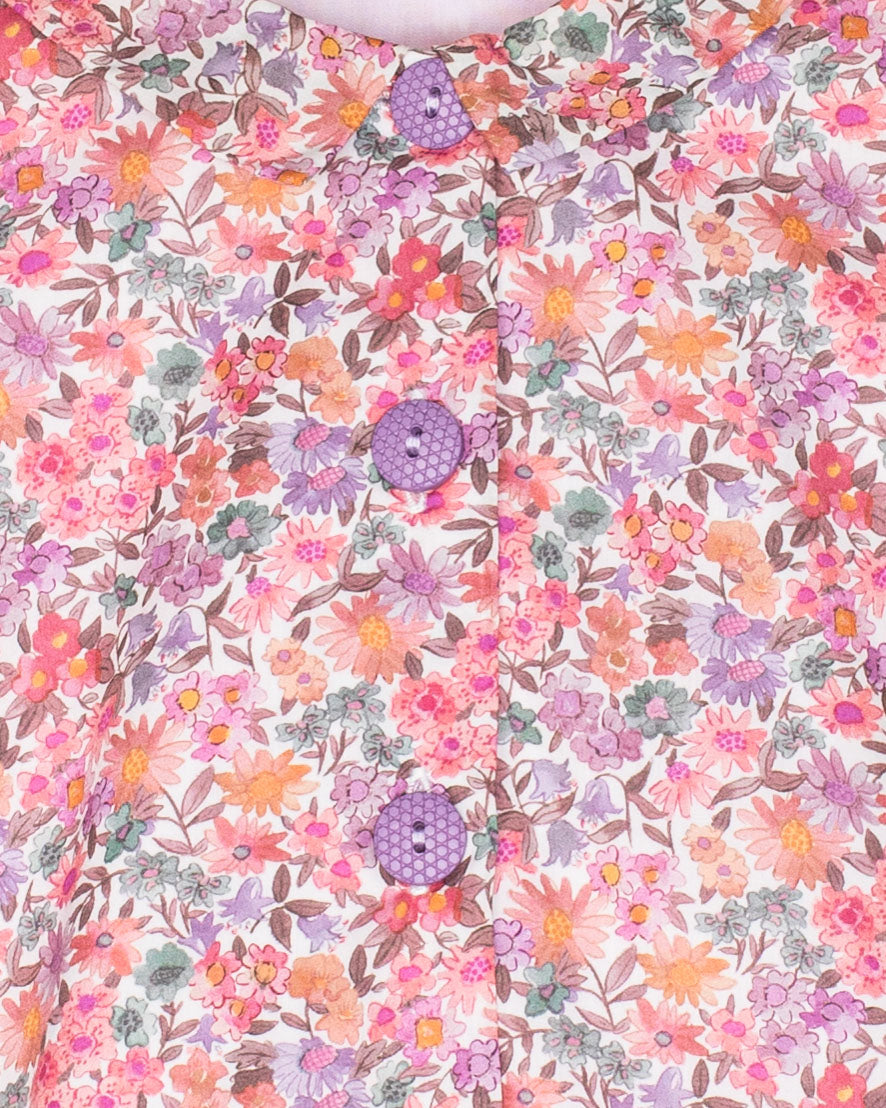 Floral patterned fabric with pink, purple, and green colors on a white background