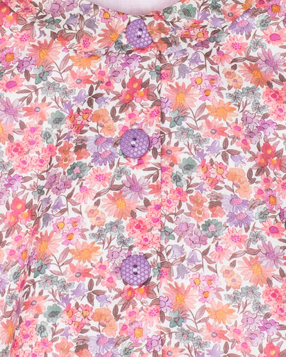 Floral patterned fabric with pink, purple, and green colors on a white background