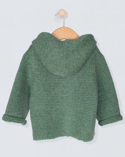 Back of Green knitted jacket on a wooden hanger against a light gray background