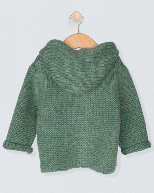 Back of Green knitted jacket on a wooden hanger against a light gray background