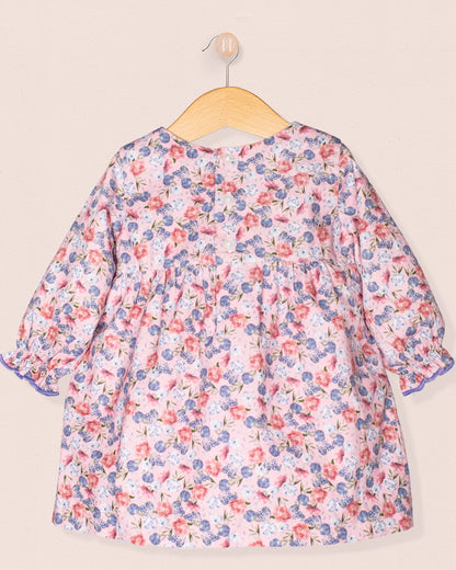 Floral dress on a hanger against a beige background-cack view