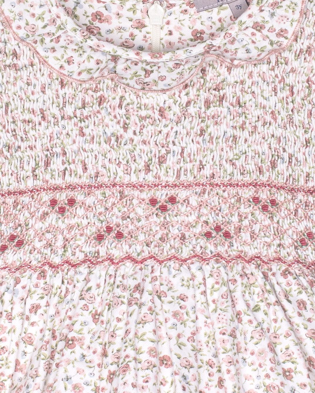 Floral patterned fabric with a visible brand label on a white background