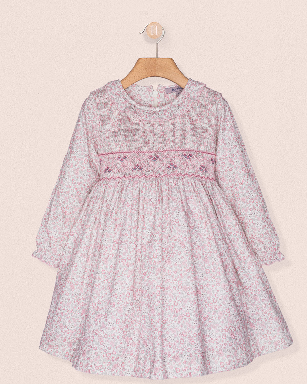 Floral dress with pink trim on a beige background