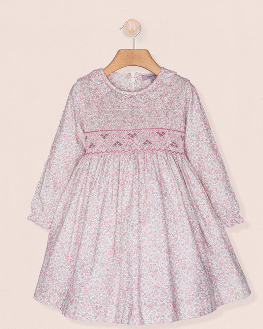 Floral dress with pink trim on a beige background