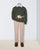 Mannequin wearing a green sweater with a dinosaur design, beige pants, and brown shoes on a white background.