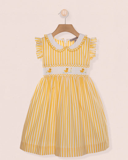 Yellow striped dress with white collar on a beige background