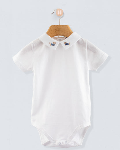 Front view of the Andreas Onesie with Embroidered Denim Dachshund, a short-sleeve white cotton jersey onesie with a crisp collar featuring embroidered dachshund dogs in denim blue sweaters.