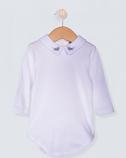 Italian cotton baby onesie with long sleeves and embroidered dachshund collar, displayed on a wooden hanger against a light background.
