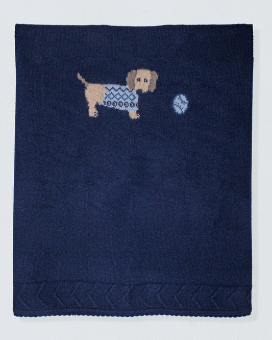 Navy blue blanket with embroidered dachshund and ball design on a light gray background