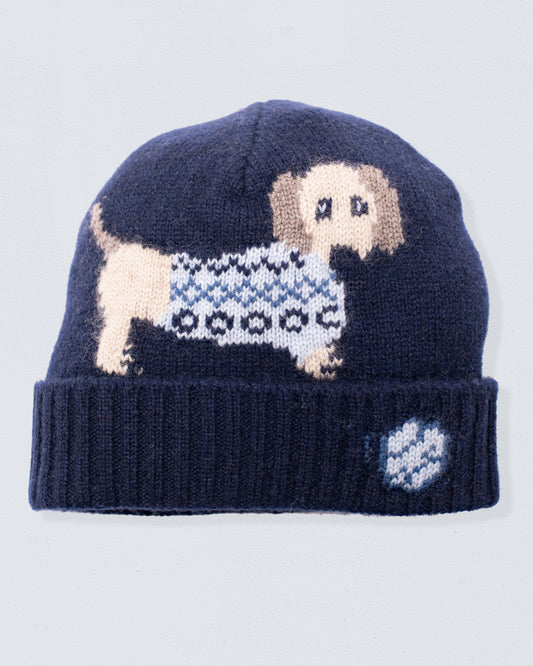 Navy blue knit beanie with a dog design on a light gray background