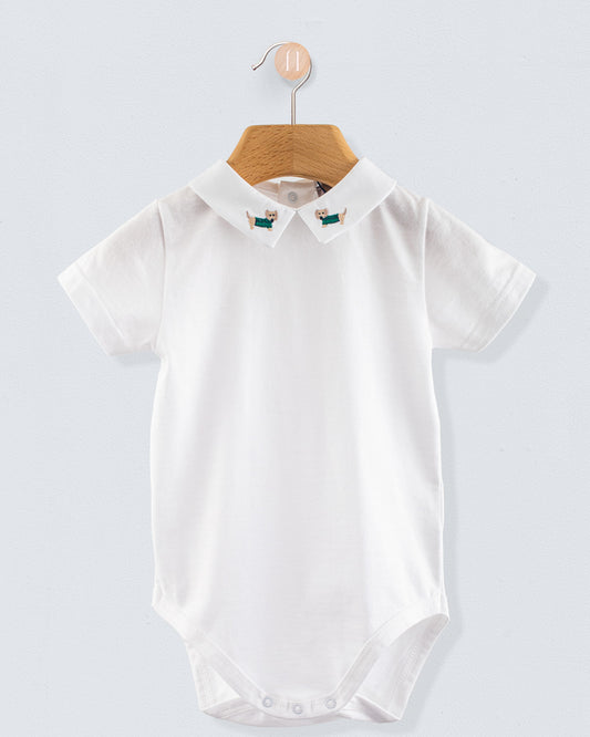 Front view of the Andreas Onesie with Embroidered Light blue Dachshund, a short-sleeve white cotton jersey onesie with a crisp collar featuring embroidered dachshund dogs in sage green sweaters.