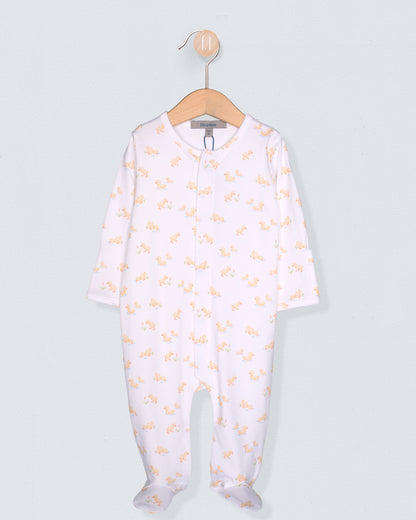 Baby onesie with yellow patterns on a hanger against a light gray background