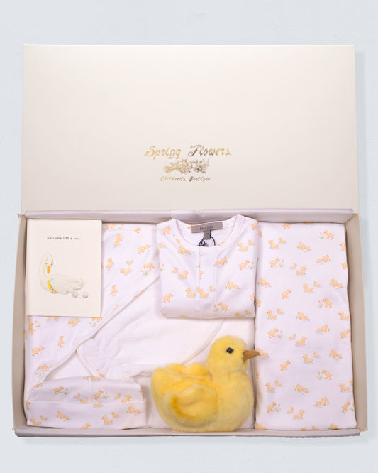 Baby gift set with white baby clothes and yellow duck toy in a box