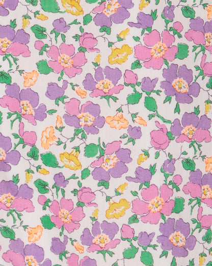 Close up of floral fabric with purple, yellow, pink and green flowers