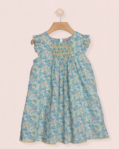 Floral dress on a hanger against a light background