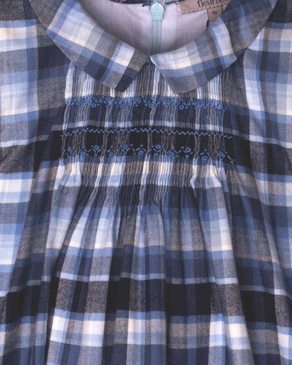 Close-up of a blue and white checkered dress with smocked waistband.