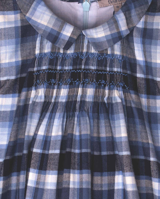 Close-up of a blue and white checkered dress with smocked waistband.