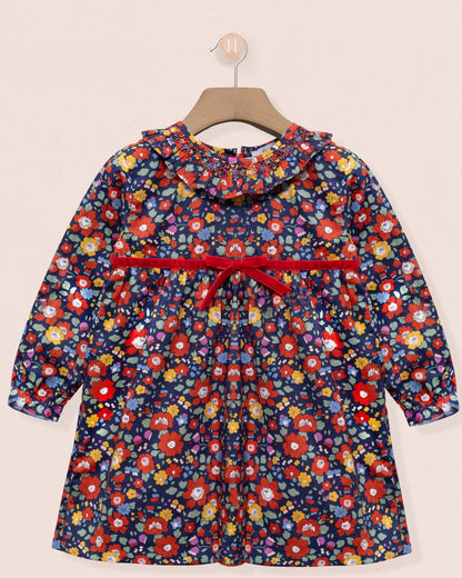 Floral-patterned dress with a red belt on a beige background