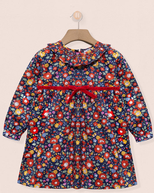 Floral-patterned dress with a red belt on a beige background