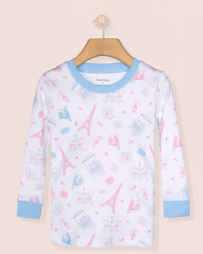 Children's pajama top with Eiffel Tower pattern on a beige background