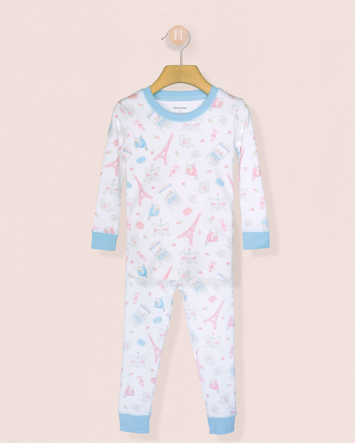 Children's pajama set with airplane pattern on a beige background