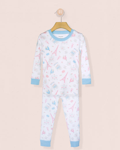 Children's pajama set with airplane pattern on a beige background