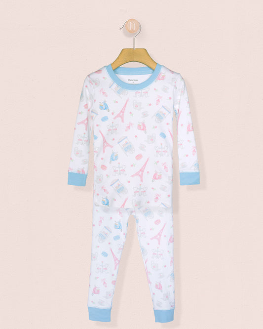 Children's pajama set with airplane pattern on a beige background