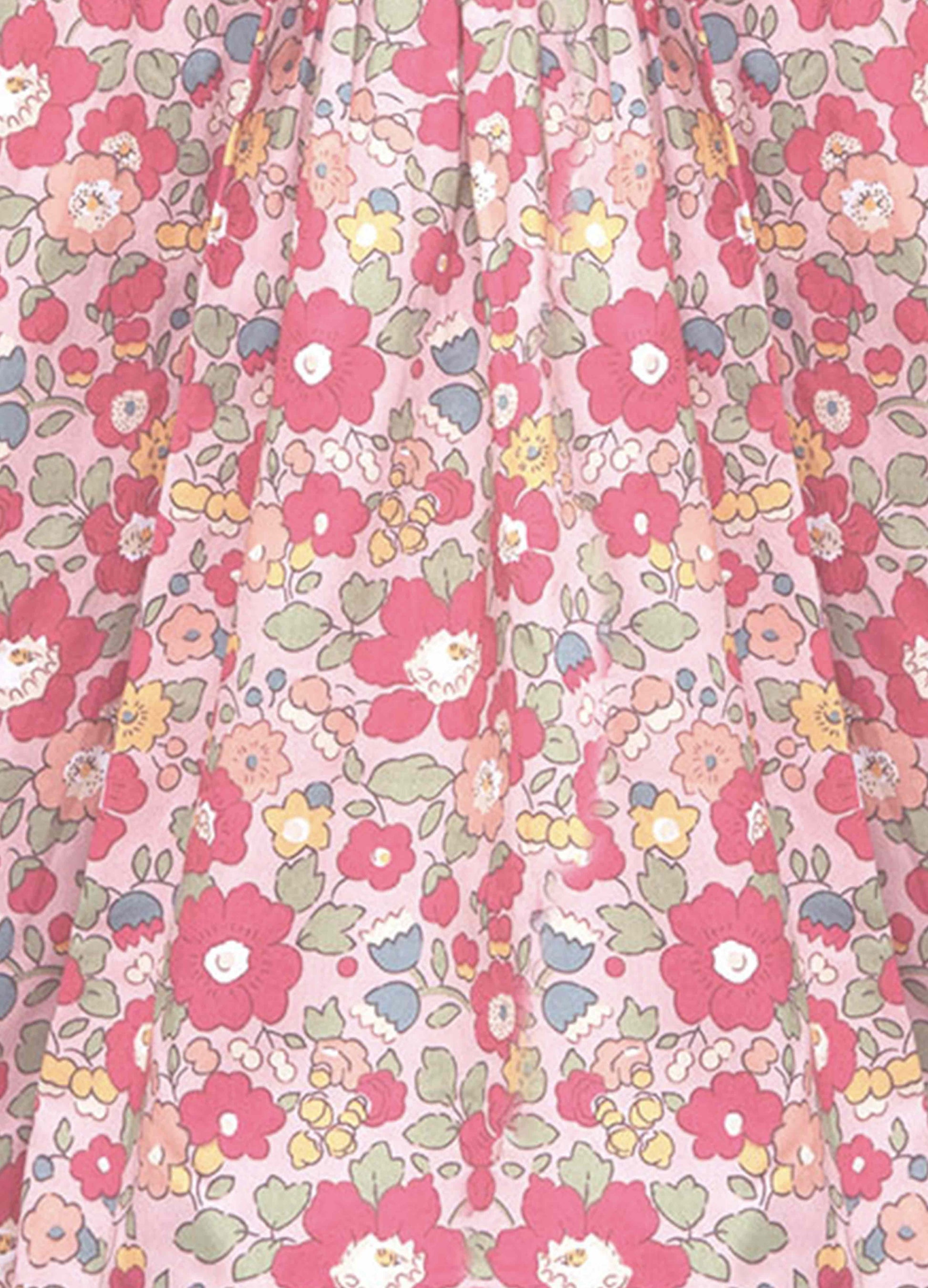 Floral patterned fabric with pink flowers on a pink background