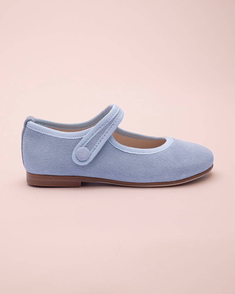Light blue shoe with a strap on a beige background