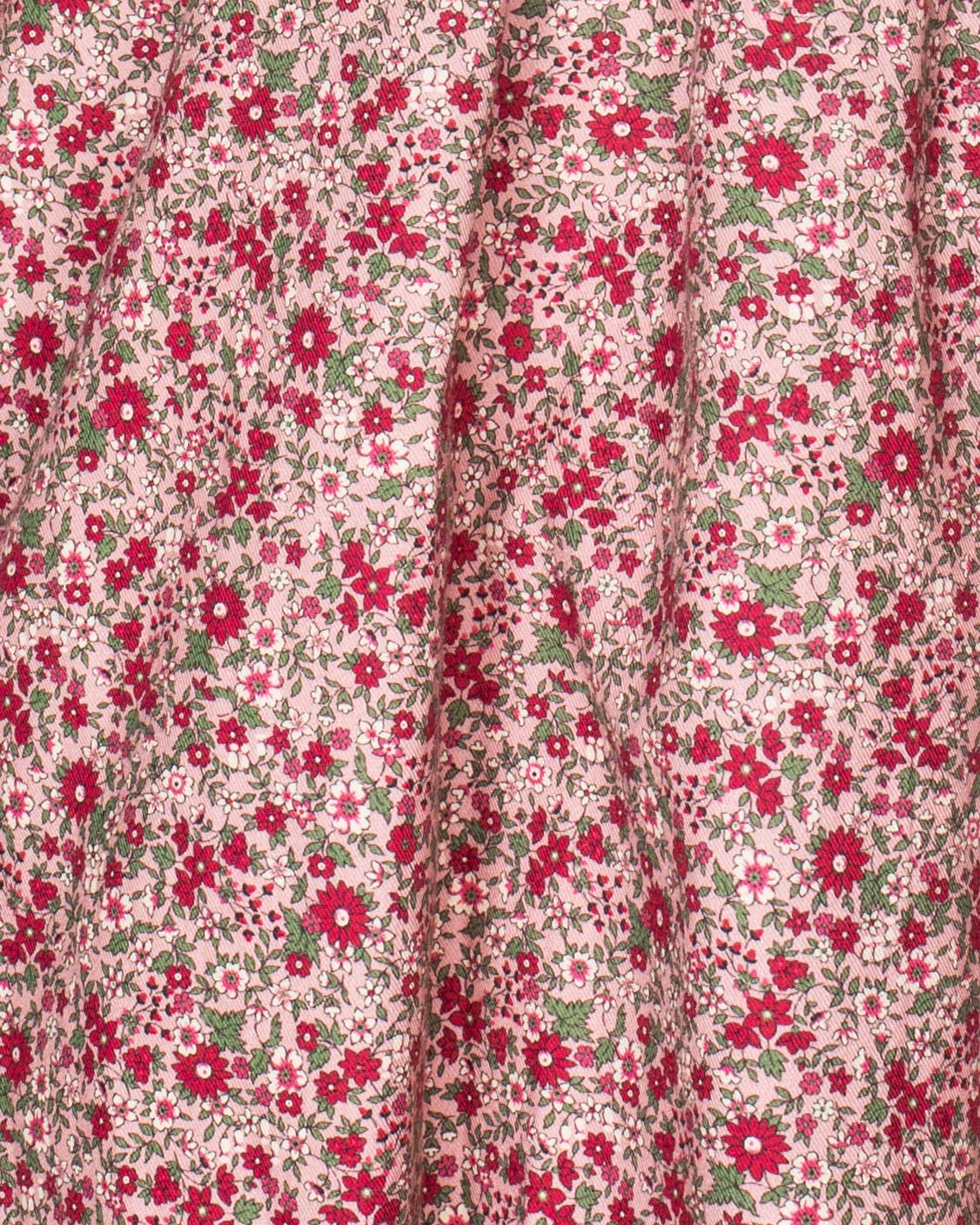 Close-up detail of the hand-smocked bodice on the Elizabeth Mini Mauve Floral Twill Dress, emphasizing fine craftsmanship and floral fabric.