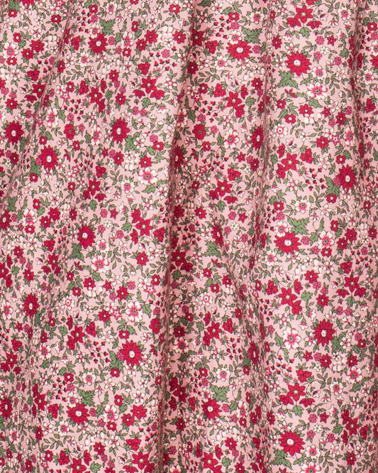 Close-up detail of the hand-smocked bodice on the Elizabeth Mini Mauve Floral Twill Dress, emphasizing fine craftsmanship and floral fabric.