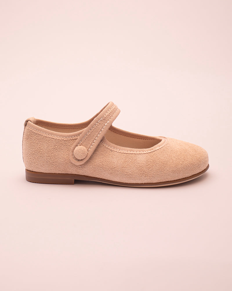 Beige shoe side view with a strap on a beige background