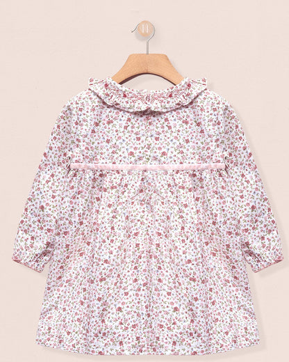 Floral patterned dress on a beige background back view