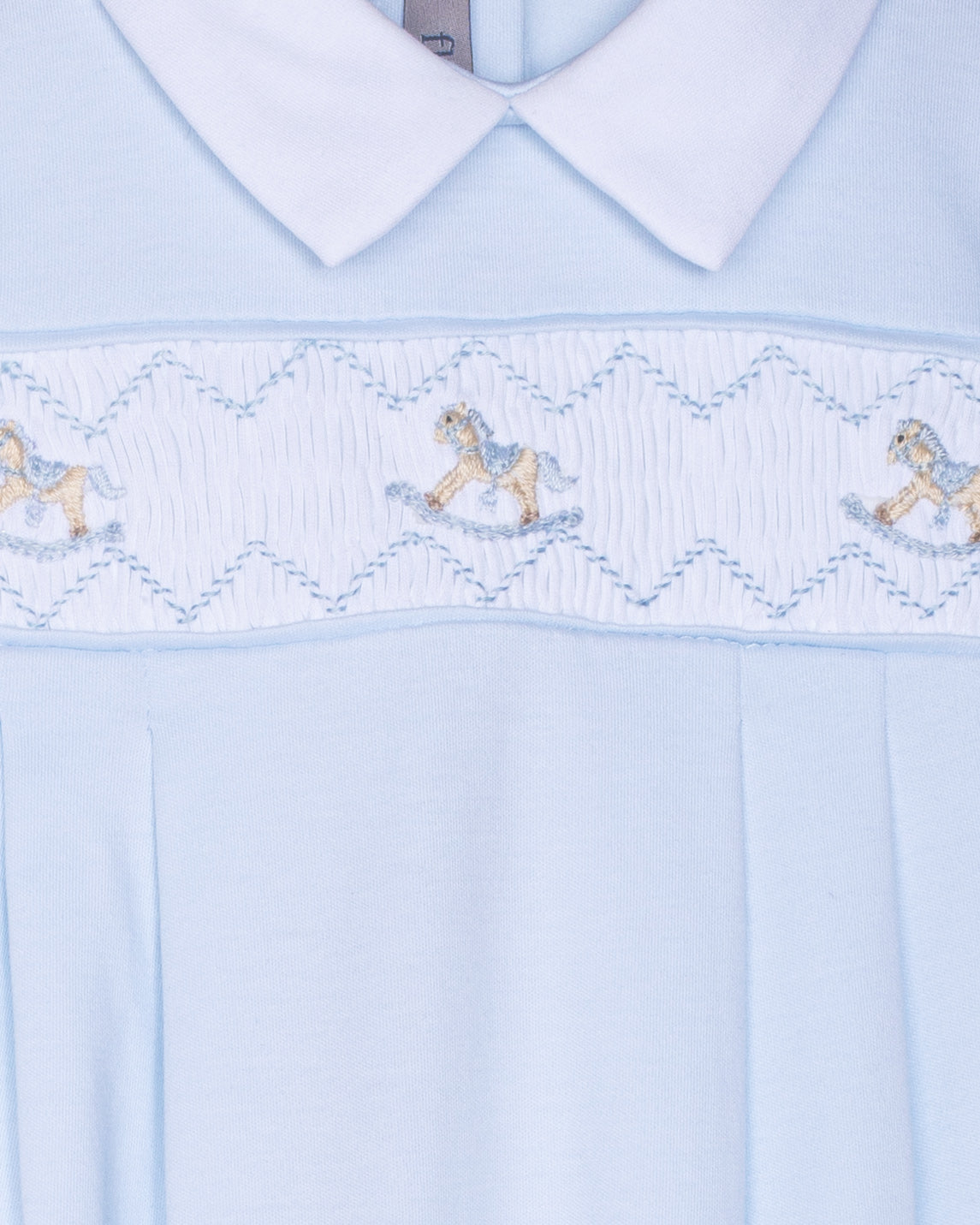 Light blue dress with embroidered details on a white background