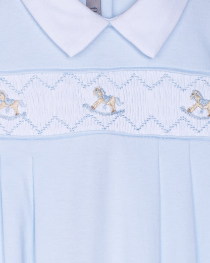 Light blue dress with embroidered details on a white background