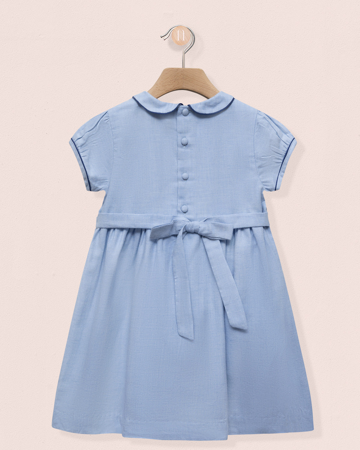 Blue dress with a collar on a beige background